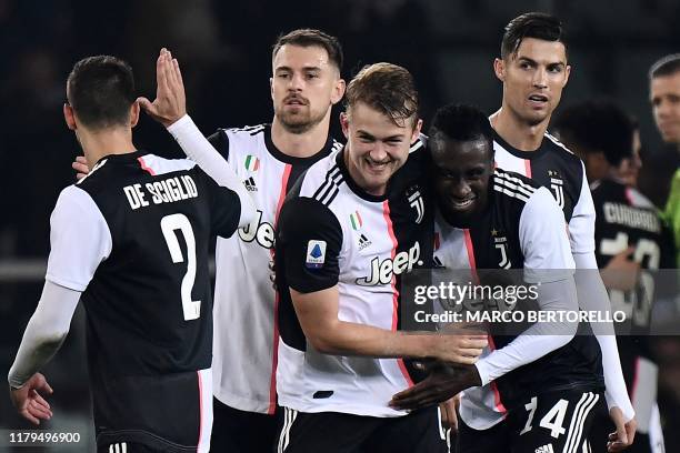 Juventus' defender Matthijs de Ligt from Netherland celebrates with Juventus' midfielder Blaise Matuidi from France at the end of the Italian Serie A...