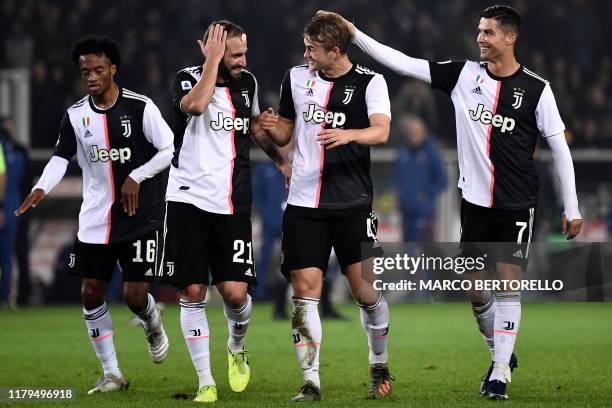 Juventus' defender Matthijs de Ligt from Netherland celebrates with Juventus' Portuguese forward Cristiano Ronaldo and Juventus' forward Gonzalo...