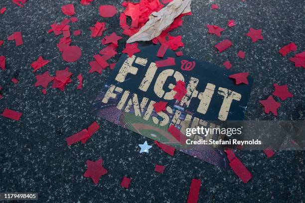 Sign is seen in confetti following the Washington Nationals parade that celebrated their World Series victory over the Houston Astros on November 2,...