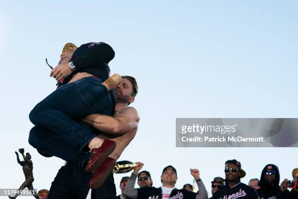 Brian Dozier of the Washington Nationals picks up Anibal Sanchez during a parade to celebrate the Washington Nationals World Series victory over the...