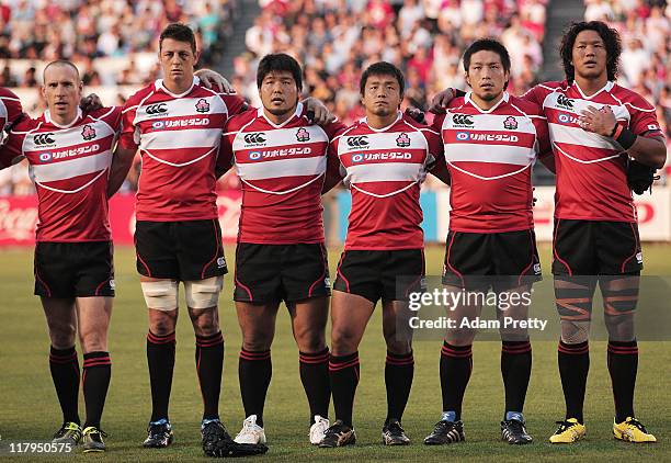 Takashi Kikutani of Japan and teamates sing the Japanese National Anthem during the IRB Pacific Nations Cup match between Japan and Samoa at Prince...