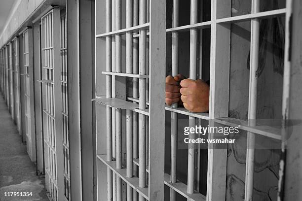 hands on cell bares - celda fotografías e imágenes de stock