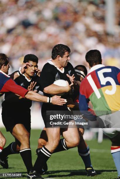 New Zealand captain Sean Fitzpatrick runs with the ball during a match against a World XV at Eden Park on April 25, 1992 in Auckland, New Zealand.