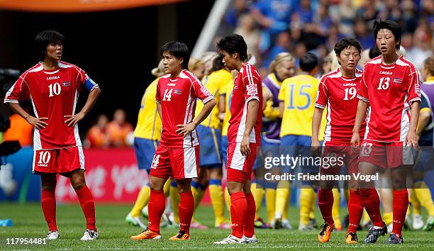 The team of Korea look dejected after the FIFA Women's World Cup 2011 Group C match between North Korea and Sweden at FIFA World Cup stadium Augsburg...