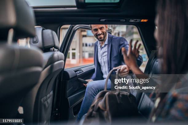 man getting in back seat of a car - taxi imagens e fotografias de stock