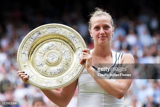 Petra Kvitova of the Czech Republic holds up the Championship trophy after winning her Ladies' final round match against Maria Sharapova of Russia on...
