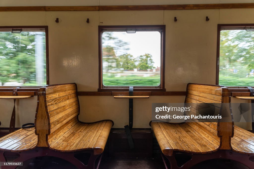 Interior of old train with wooden benches