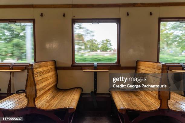 interior of old train with wooden benches - treincoupé stockfoto's en -beelden