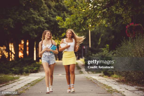 college girls walking to classes together - mini shorts stock pictures, royalty-free photos & images