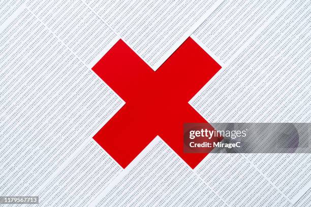 red cross multiplication sign made of data sheets pile - red cross stock-fotos und bilder