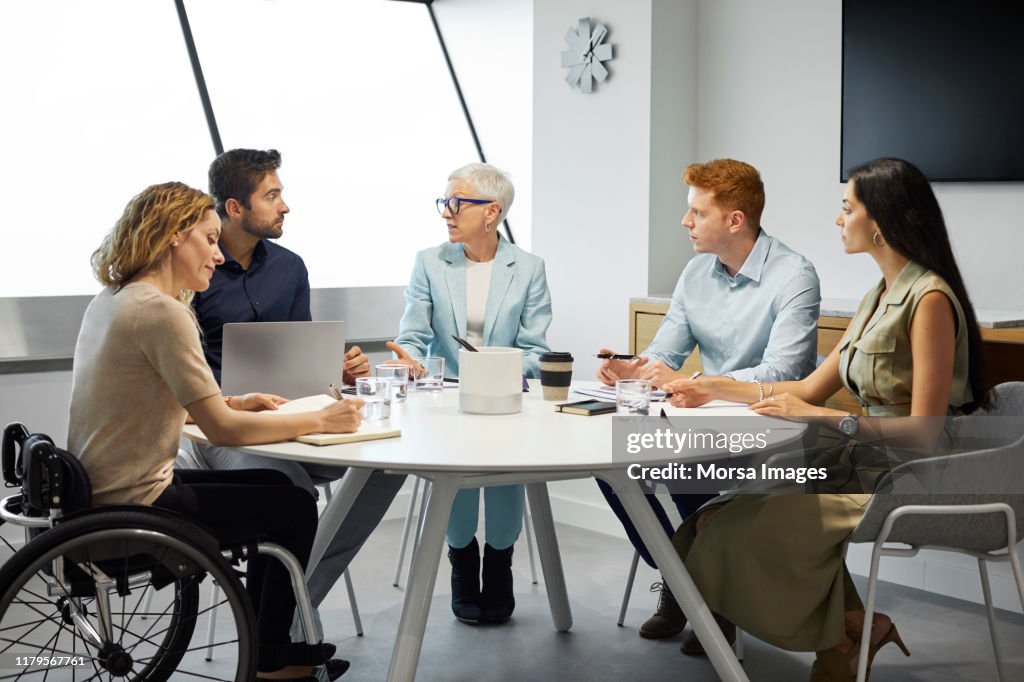 Colleagues planning strategy in meeting at office