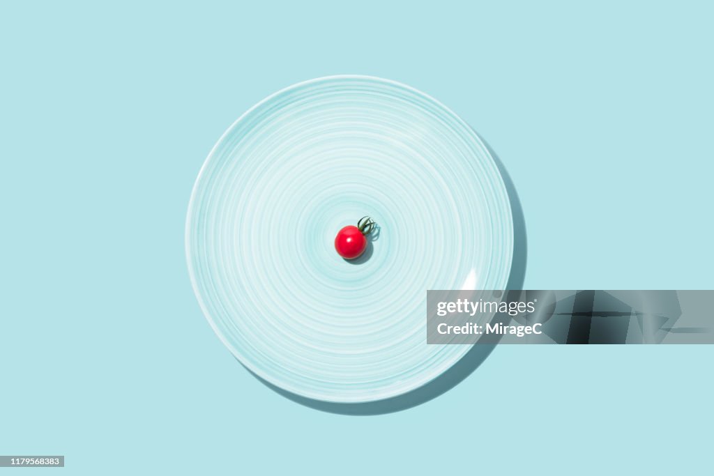 Small Cherry Tomato With Big Blue Plate