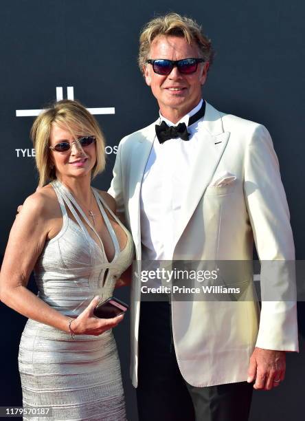 John Schneider and guest attend Tyler Perry Studios Grand Opening Gala - Arrivals at Tyler Perry Studios on October 5, 2019 in Atlanta, Georgia.