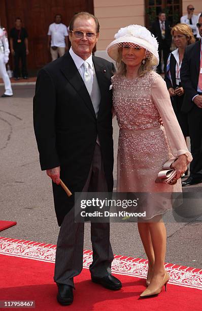 Sir Roger Moore and his wife Kristina Tholstrup attend the religious ceremony of the Royal Wedding of Prince Albert II of Monaco to Princess Charlene...