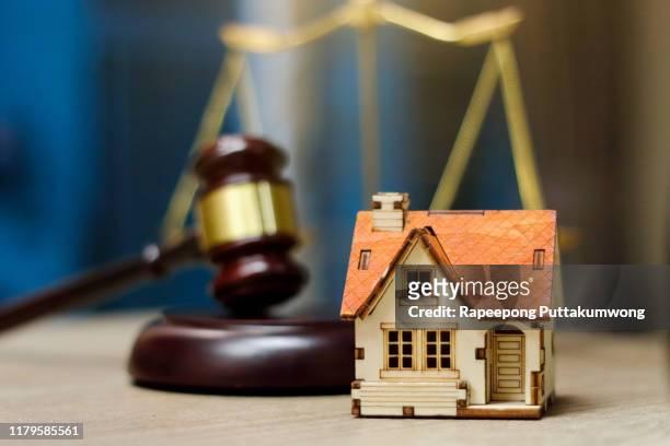 real estate law concept. judge gavel and house model on table - real estate auction stock pictures, royalty-free photos & images