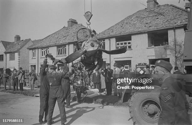 The wrecked engine of a German Luftwaffe Heinkel bomber is removed from the scene after crashing in Victoria Road, Clacton-on-Sea, Essex during World...