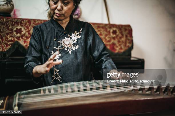 chinese woman playing traditional harp - zither stock pictures, royalty-free photos & images