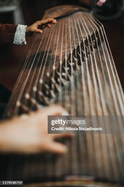 close up of hands of a chinese woman playing a zither, a traditional chinese musical instrument - zither stock pictures, royalty-free photos & images