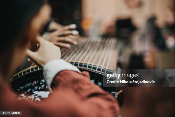 chinese grandmother and grandson and traditional harp - zither stock pictures, royalty-free photos & images