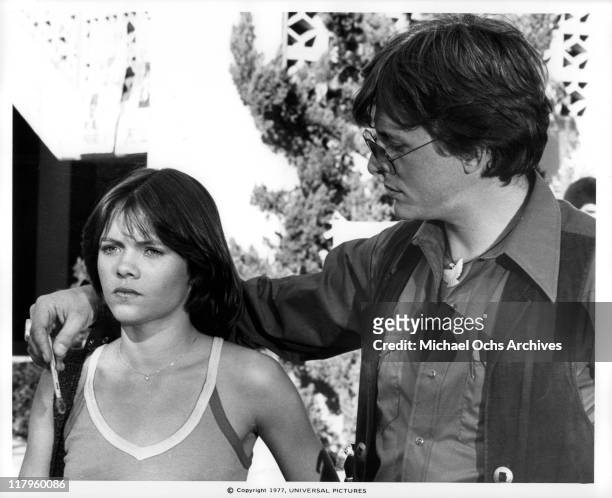 David Wilson putting his hand around Donna Wilkes's shoulder in a scene from the film 'Almost Summer', 1978.