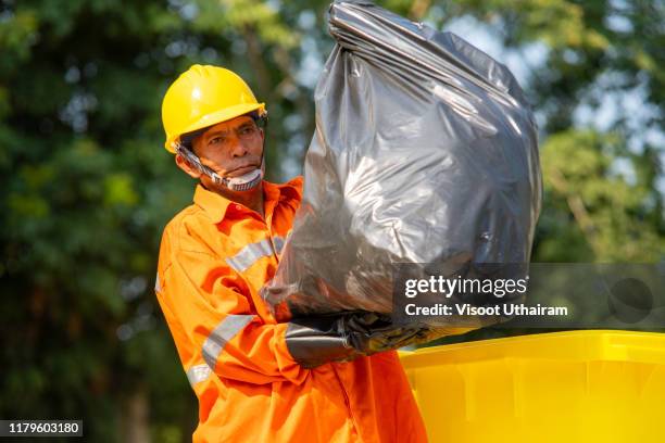 worker of urban municipal recycling garbage collector - müllmann stock-fotos und bilder