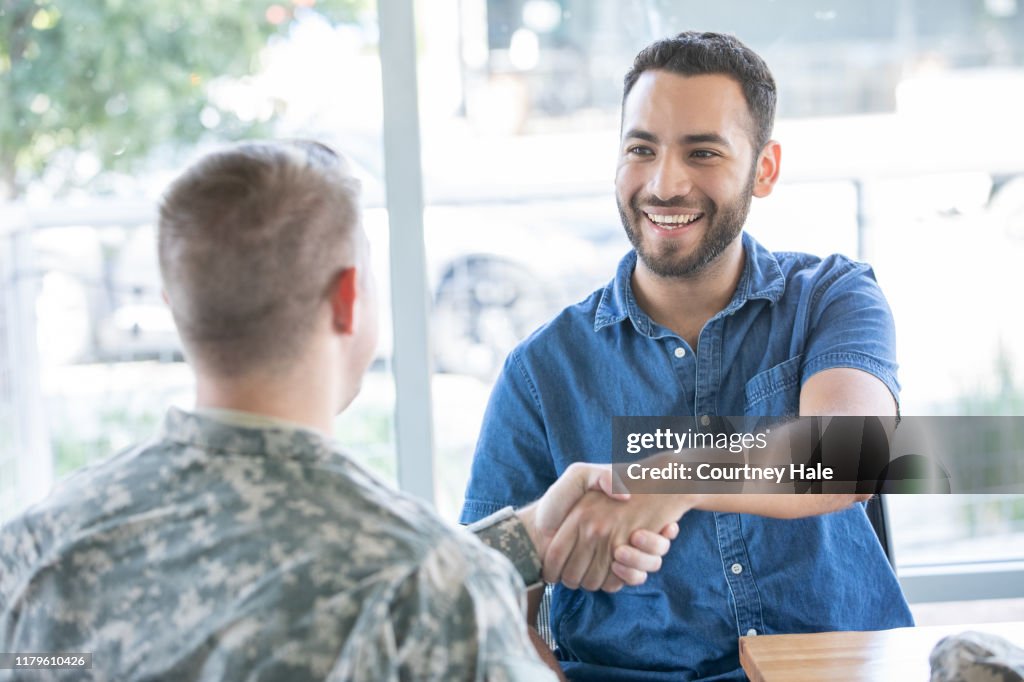 Young man meeting with military recruiter