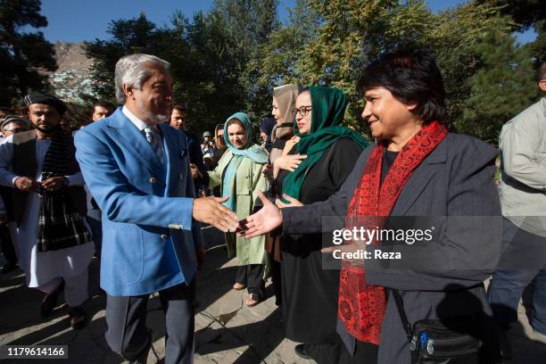 On the voting day, the candidate Dr Abdullah shakes the hand of Shulira Heydar, an afghan women activist whom counselled him during his campaign. The...