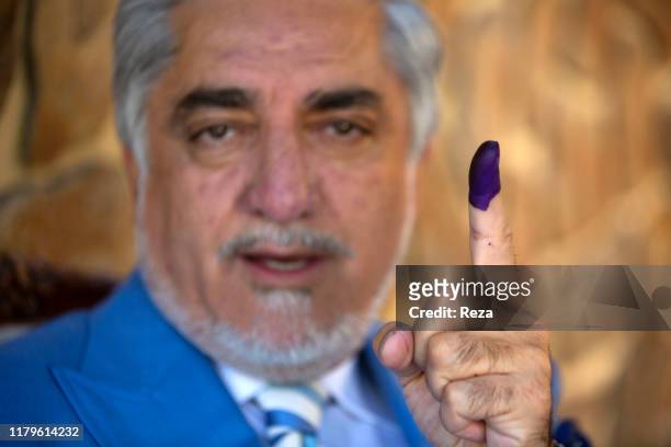 On the voting day, portrait of the candidate Dr Abdullah his finger is inked in blue to prove he voted. Dr Abdullah Abdullah is an Afghan political...