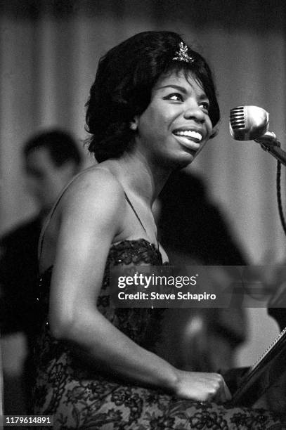 American Jazz, R&B, and Folk musician Nina Simone sits at a piano as she performs at the Apollo Theater, New York, New York, 1961.