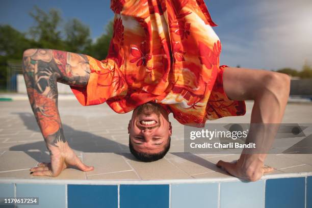 smiling breakdancer headspin street dance - breakdancing headspin stock pictures, royalty-free photos & images