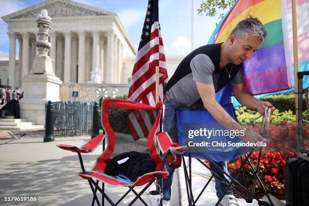 Eddie Reynoso attaches a safety whistle to his chair while waiting in line outside the U.S. Supreme Court building for the chance to attend Tuesday's...