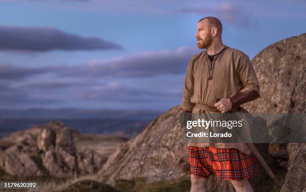 scottish redhead warrior wearing a kilt - kilt stock pictures, royalty-free photos & images