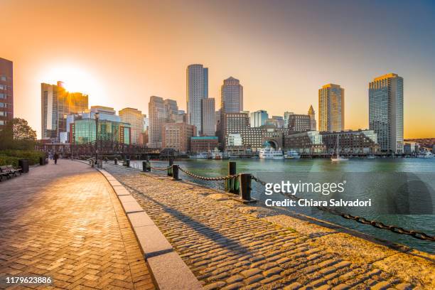 boston skyline at the sunset - boston massachusetts stock-fotos und bilder