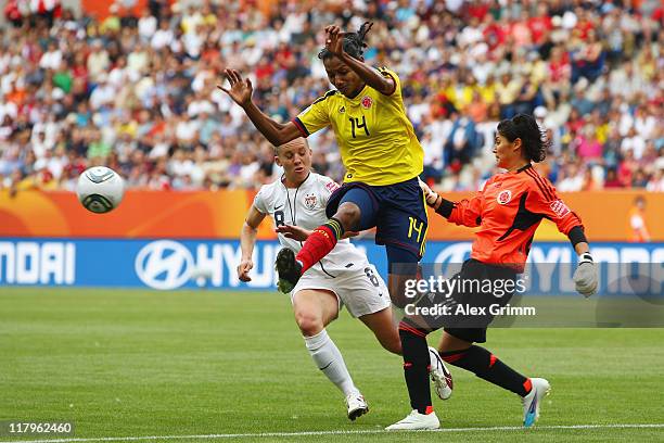 Amy Rodriguez of USA is challenged by Kelis Peduzine and Goalkeeper Sandra Sepulveda of Colombia during the FIFA Women's World Cup 2011 Group C match...
