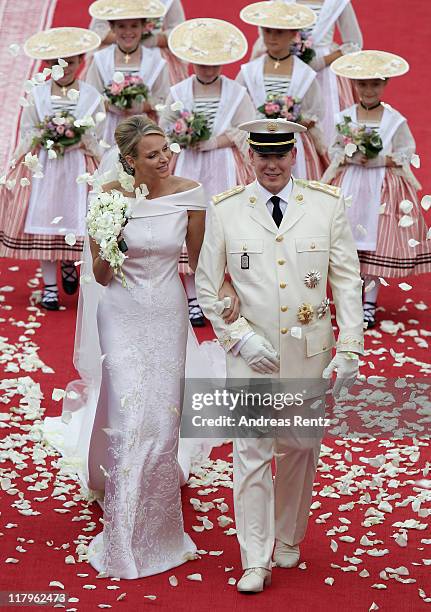 Princess Charlene of Monaco and Prince Albert Of Monaco smile as they leave the palace after the religious ceremony of the Royal Wedding of Prince...