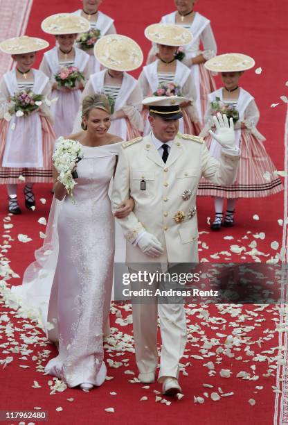 Princess Charlene of Monaco and Prince Albert Of Monaco smile as they leave the palace after the religious ceremony of the Royal Wedding of Prince...