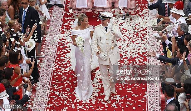 Princess Charlene of Monaco and Prince Albert Of Monaco smile as they leave the palace after the religious ceremony of the Royal Wedding of Prince...