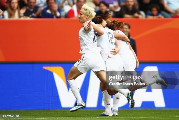 Megan Rapinoe of USA celebrates with her team mates after scoring her team's second goal during the FIFA Women's World Cup 2011 Group C match between...