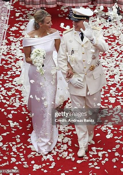 Princess Charlene of Monaco and Prince Albert Of Monaco smile as they leave the palace after the religious ceremony of the Royal Wedding of Prince...