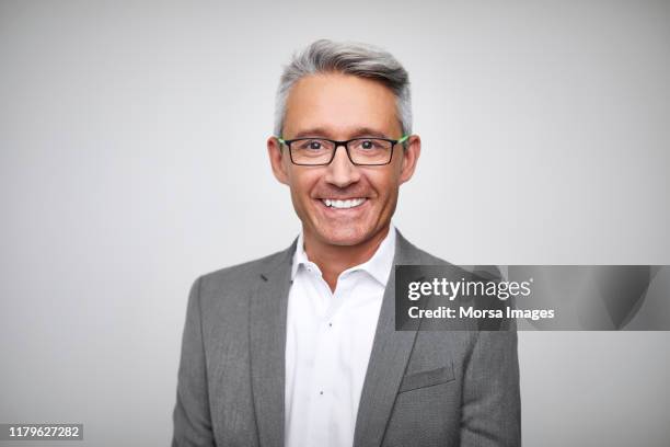 smiling mature male ceo wearing gray suit - male portrait white background stock-fotos und bilder