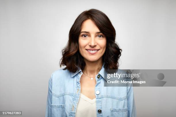 happy female brunette ceo wearing blue denim shirt - mature brunette woman stockfoto's en -beelden