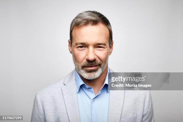 close-up of mature male leader wearing gray suit - gray suit stock pictures, royalty-free photos & images