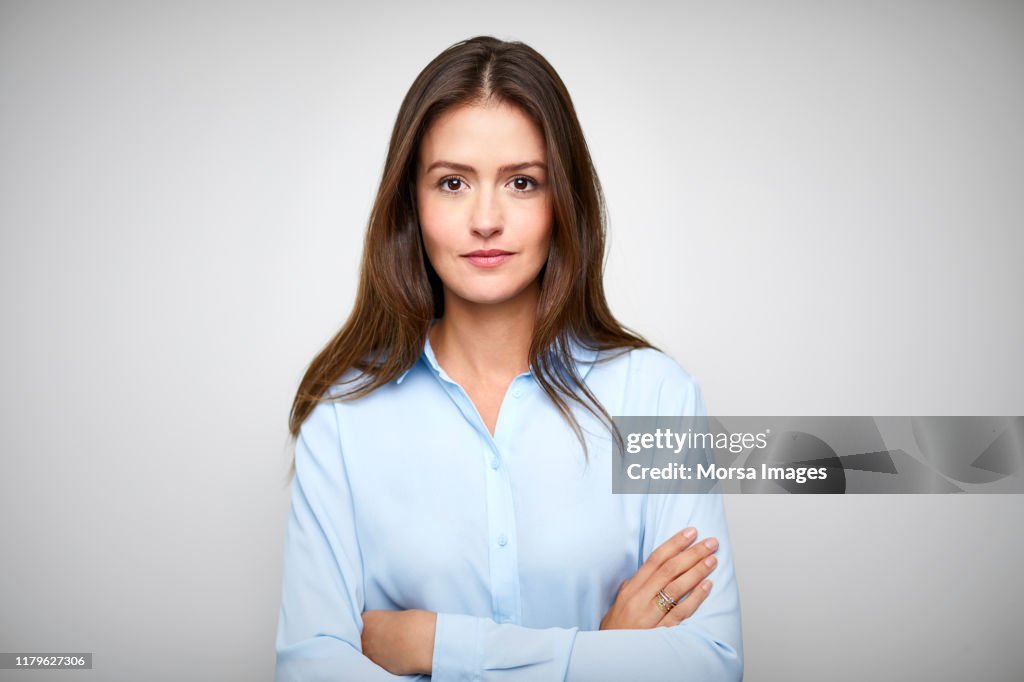 Female white collar worker with arms crossed