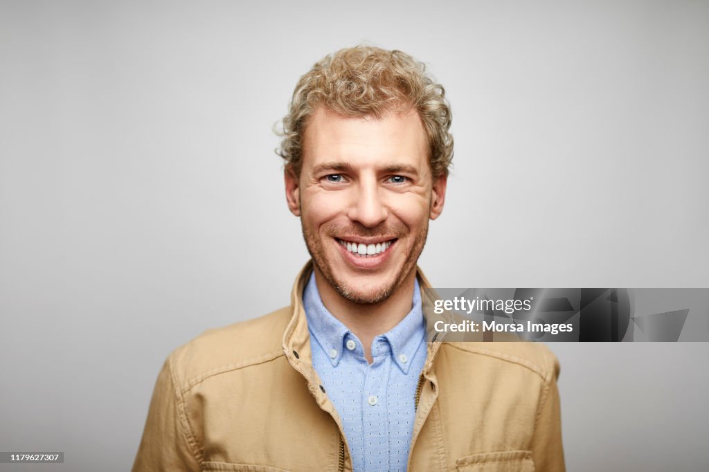 Portrait of smiling blond male design professional