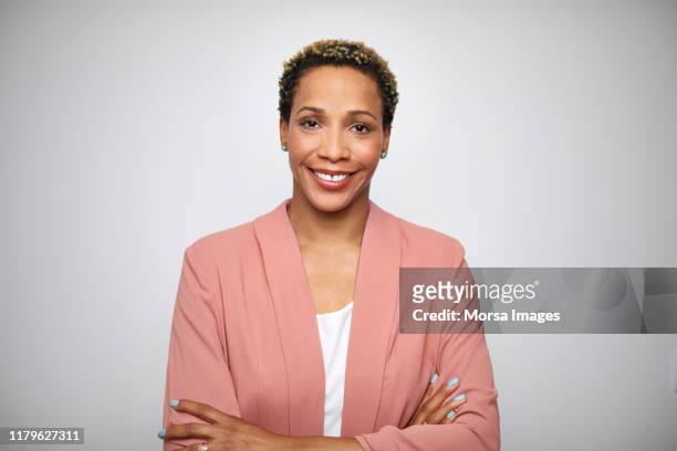 mature female entrepreneur with arms crossed - short hair stock pictures, royalty-free photos & images