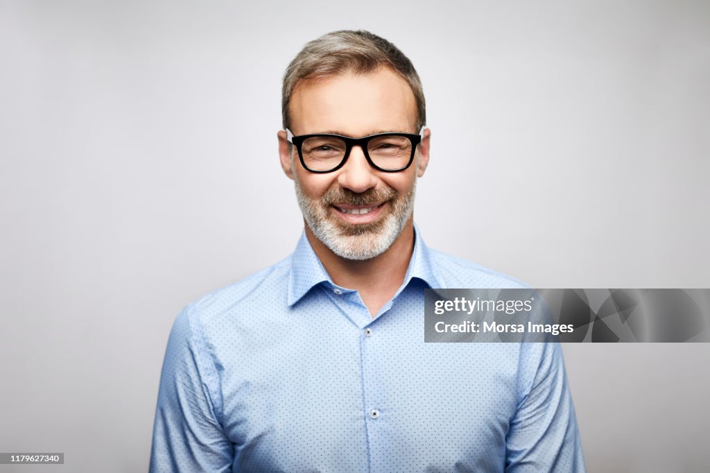 Close-up smiling male leader wearing eyeglasses