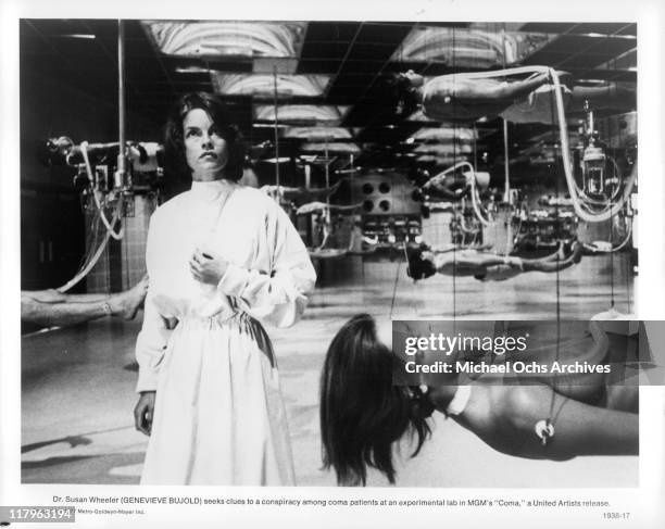 Genevieve Bujold seeks clues to a conspiracy among coma patients at an experimental lab in a scene from the film 'Coma', 1977.