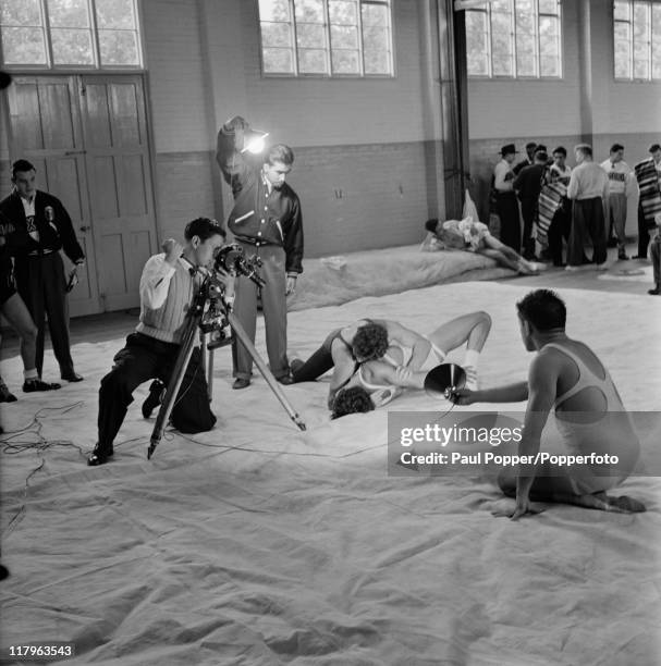 Mexican crew filming Mexican wrestler Jose Luis Perez in training at a gym at the Olympic village in Richmond, Surrey, during the London Olympics,...