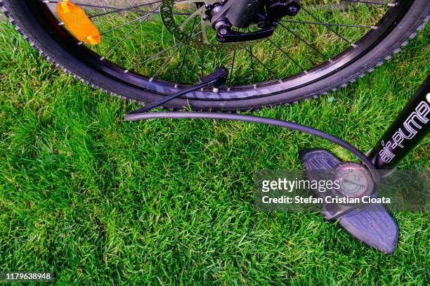 filling bicycle tires with air pump stock photo - bicycle tire stockfoto's en -beelden