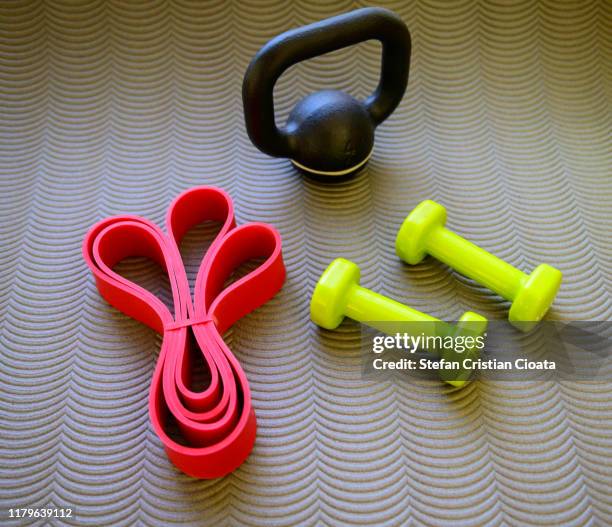 kettlebell, dumbbell on yoga mat - accessory stock pictures, royalty-free photos & images